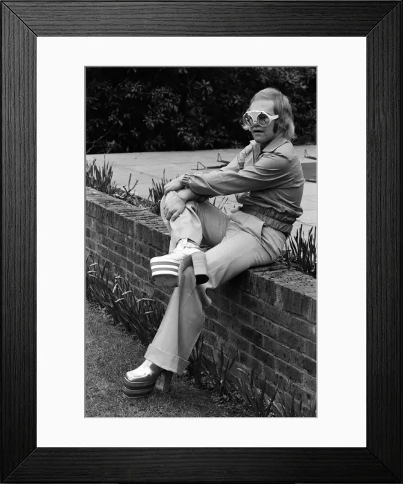 Framed Print : Elton John, singer, pictured at home in Virginia Water. He is wearing platform boots Framed Print : Elton John, singer, pictured at home in Virginia Water. He is wearing platform boots