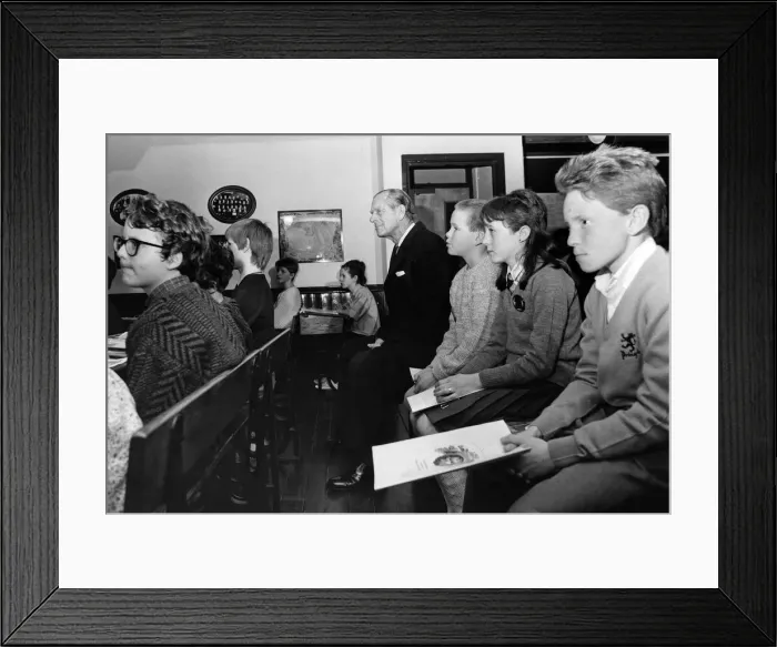 Framed Print : Prince Philip, Duke of Edinburgh takes a seat in the Heritage Centre classroom at Wigan