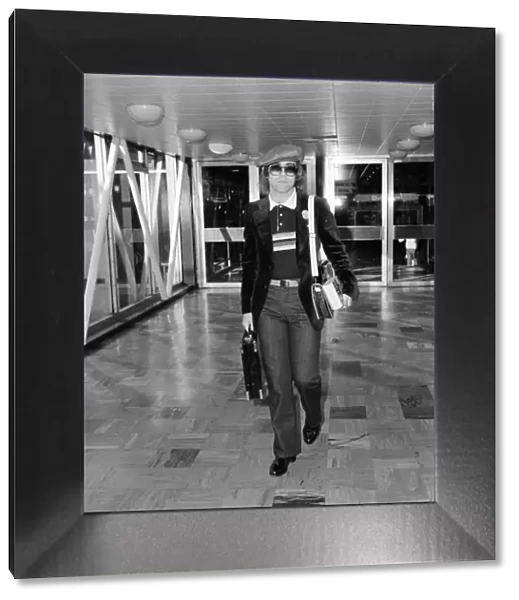 Elton John leaving Heathrow Airport for Los Angeles. November 1977