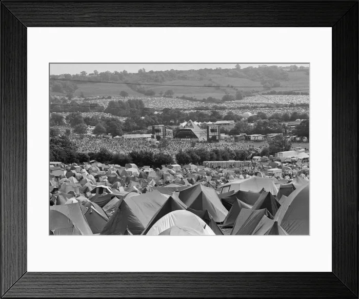 Framed Print : Glastonbury Festival, Pilton, Somerset. Picture shows scenes from the 1993 festival. Hundred of tents and thousands of people enjoy the music from The Pyramid Stage seen in the distance Framed Print : Glastonbury Festival, Pilton, Somerset. Picture shows scenes from the 1993 festival. Hundred of tents and thousands of people enjoy the music from The Pyramid Stage seen in the distance