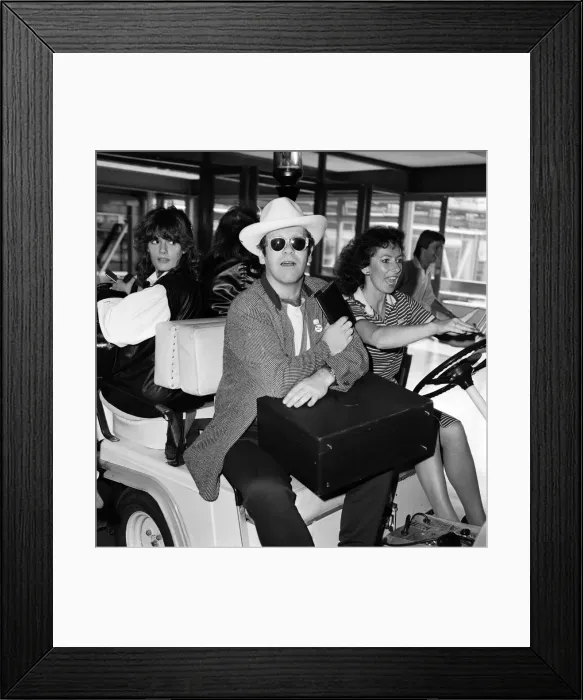 Framed Print : Elton John pictured at Heathrow airport. 1st June 1982