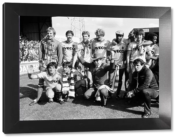 Elton John and the Watford side pose for the photographers after their match against