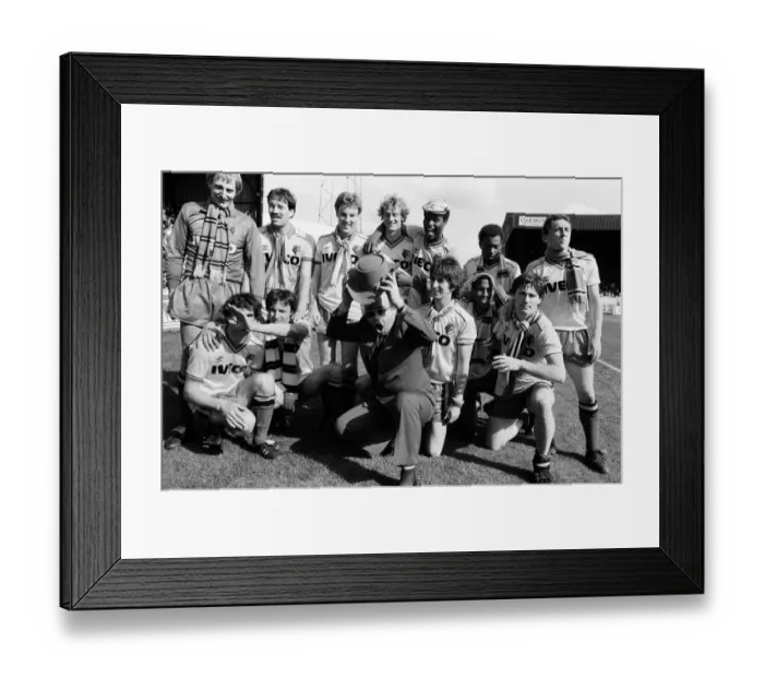 Framed Print : Elton John and the Watford side pose for the photographers after their match against