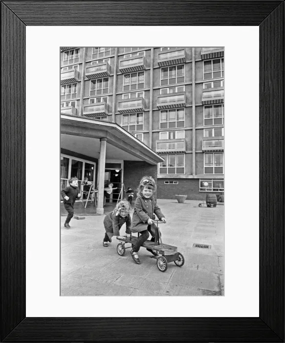 Framed Print : Rose Anne Kelly rides the trike with her sister Christina pushing during break time