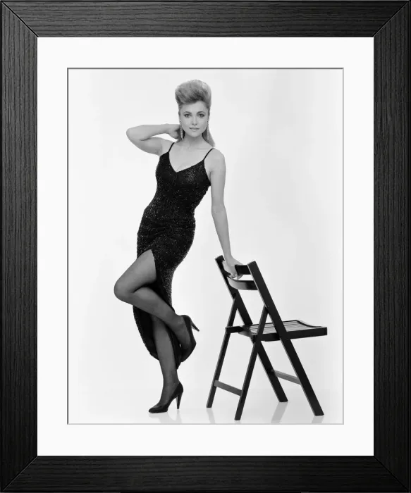 Framed Print : Emma Samms, British actress, studio pix wearing Nolan Miller designed black dress