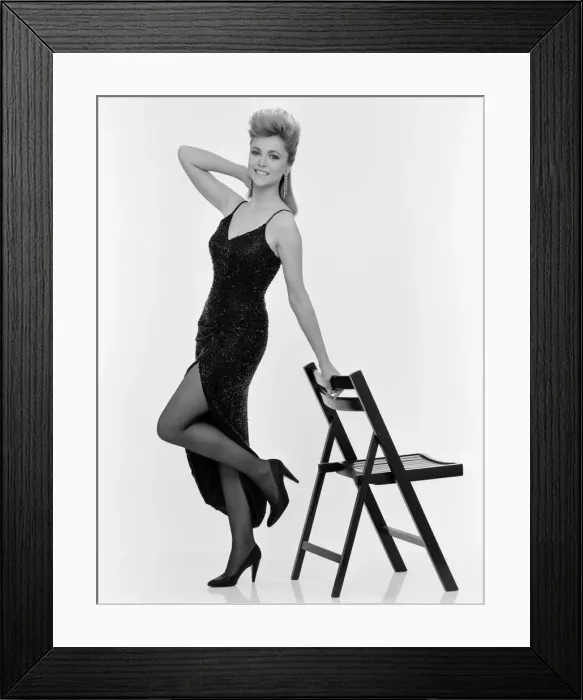 Framed Print : Emma Samms, British actress, studio pix wearing Nolan Miller designed black dress