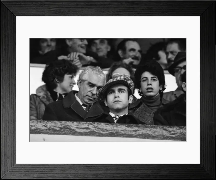 Framed Print : Elton John watching the West Ham United v Watford football match. 7th January 1978 Framed Print : Elton John watching the West Ham United v Watford football match. 7th January 1978