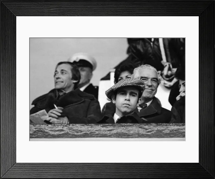 Framed Print : Elton John watching the West Ham United v Watford football match. 7th January 1978 Framed Print : Elton John watching the West Ham United v Watford football match. 7th January 1978