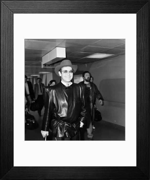 Framed Print : Elton John arriving at Heathrow airport from Copenhagen. 7th May 1982 Framed Print : Elton John arriving at Heathrow airport from Copenhagen. 7th May 1982