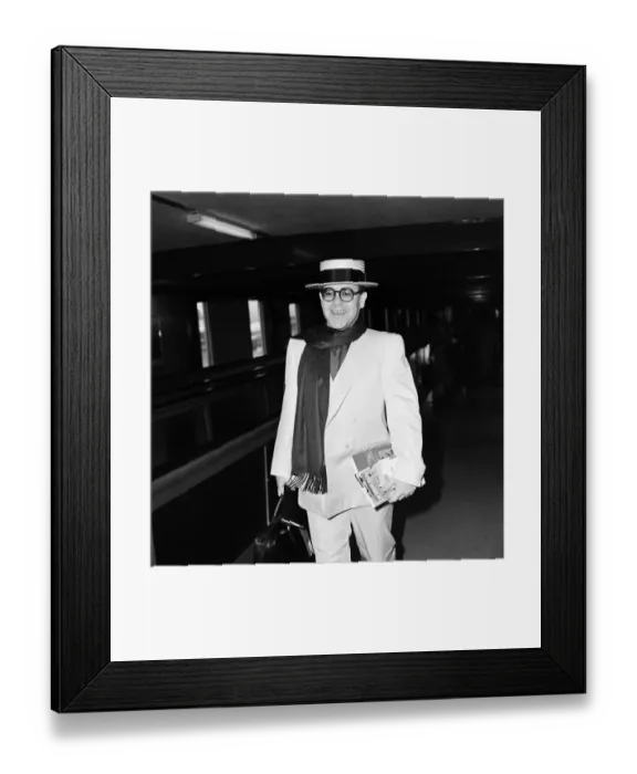 Framed Print : Elton John leaving Heathrow Airport for Barbados on his way to make a new record Framed Print : Elton John leaving Heathrow Airport for Barbados on his way to make a new record