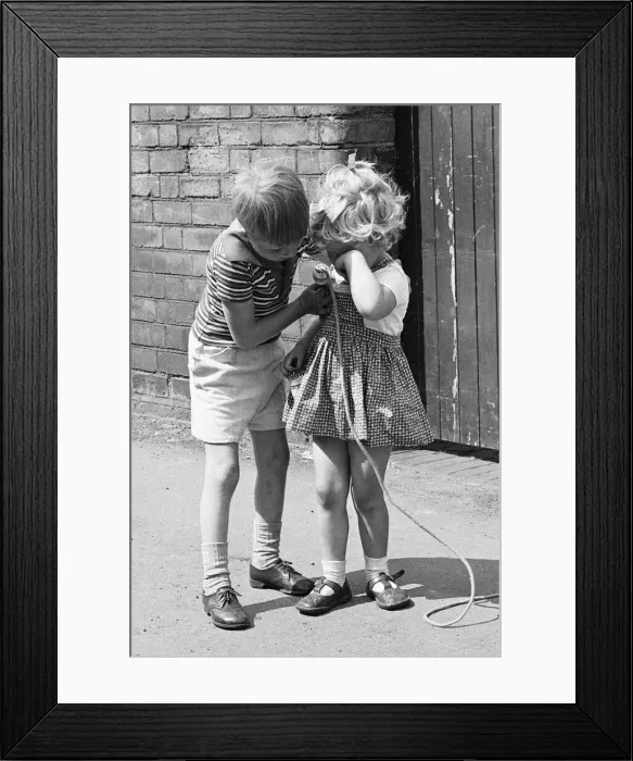 Framed Print : A brother comforts his sister during the long summer school holidays as she has no one to Framed Print : A brother comforts his sister during the long summer school holidays as she has no one to