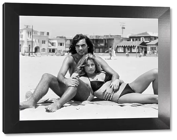 George Best at Hermosa Beach, Los Angeles, California, with his new girlfriend Heidi