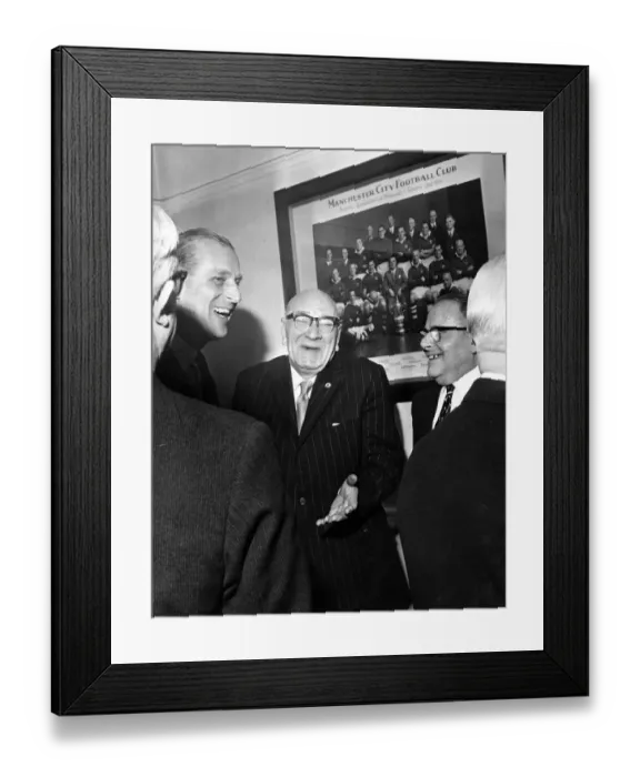 Framed Print : Prince Philip, Duke of Edinburgh shares a joke with Directors in the board room at Maine