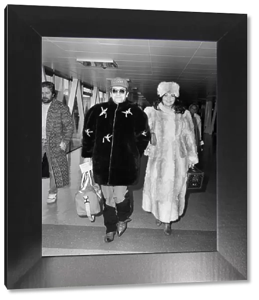 Elton John and wife Renate leaving Heathrow Airport for Washington where he is to play