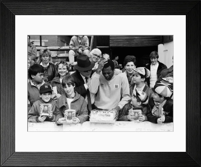Framed Print : Pop star and Watford FC Chairman, Elton John, handing out Easter eggs to fans Framed Print : Pop star and Watford FC Chairman, Elton John, handing out Easter eggs to fans