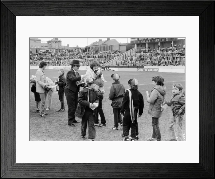 Framed Print : Pop star and Watford FC Chairman, Elton John, handing out Easter eggs to fans Framed Print : Pop star and Watford FC Chairman, Elton John, handing out Easter eggs to fans