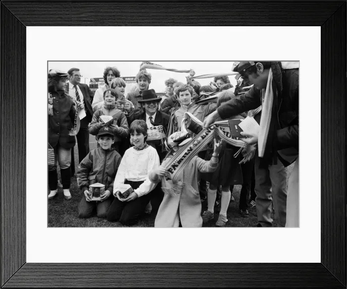 Framed Print : Pop star and Watford FC Chairman, Elton John, handing out Easter eggs to fans Framed Print : Pop star and Watford FC Chairman, Elton John, handing out Easter eggs to fans