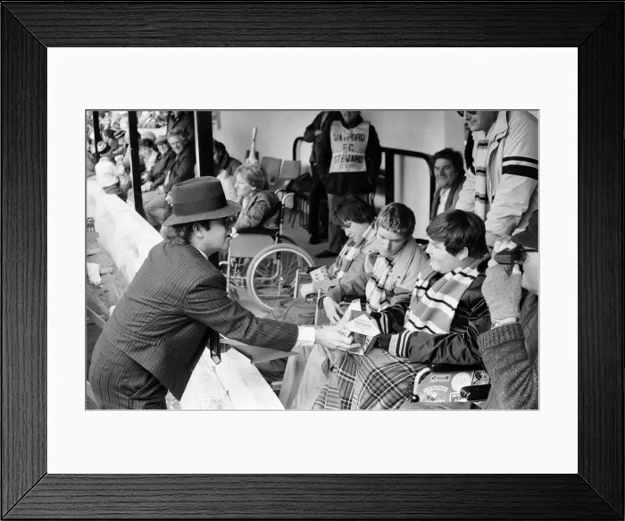 Framed Print : Pop star and Watford FC Chairman, Elton John, handing out Easter eggs to fans Framed Print : Pop star and Watford FC Chairman, Elton John, handing out Easter eggs to fans