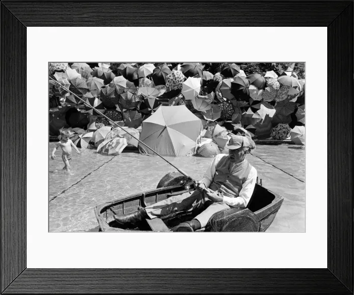 Framed Print : Joe Carver, owner of an umbrella making business, sits in a fishing boat smoking a cigar Framed Print : Joe Carver, owner of an umbrella making business, sits in a fishing boat smoking a cigar