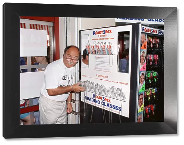 Ex footballer Jimmy Greaves at the worlds first spectacle vending machine