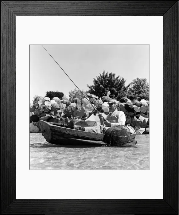 Framed Print : Joe Carver, owner of an umbrella making business, sits in a fishing boat smoking a cigar Framed Print : Joe Carver, owner of an umbrella making business, sits in a fishing boat smoking a cigar
