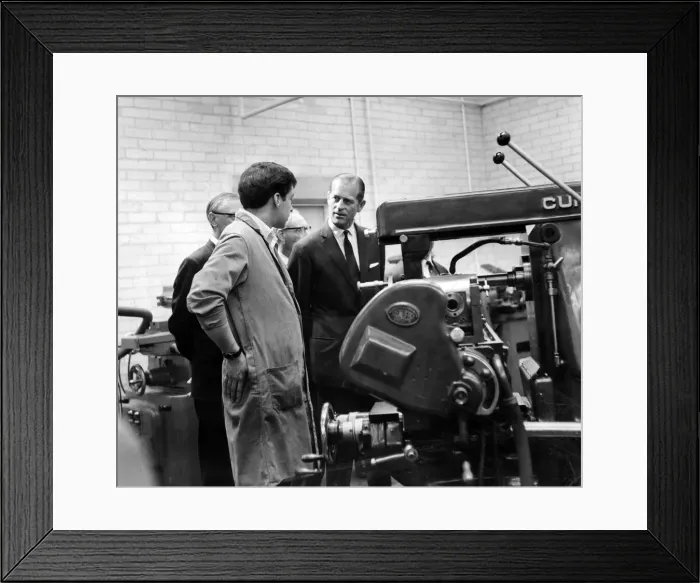 Framed Print : Prince Philip, Duke of Edinburgh talks to 20-year-old Russell Thomas as he operates a Framed Print : Prince Philip, Duke of Edinburgh talks to 20-year-old Russell Thomas as he operates a