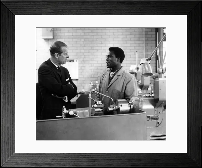 Framed Print : Prince Philip, Duke of Edinburgh takes an interest in the work of Adeddyin Otenaike of