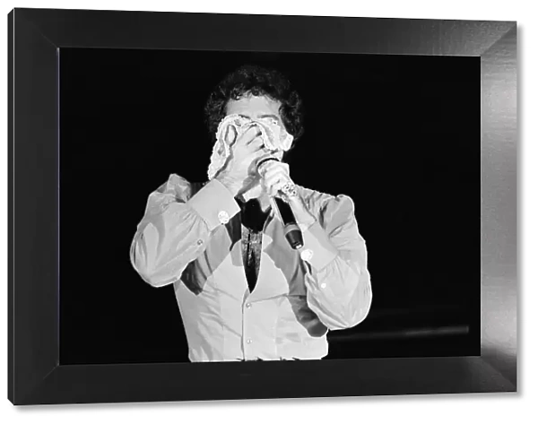 Tom Jones in concert in America. Tom wipes his face on a pair of knickers. April 1983