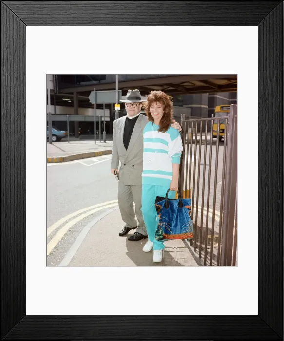 Framed Print : Elton John and his wife Renate at London Airport. 29th July 1988 Framed Print : Elton John and his wife Renate at London Airport. 29th July 1988