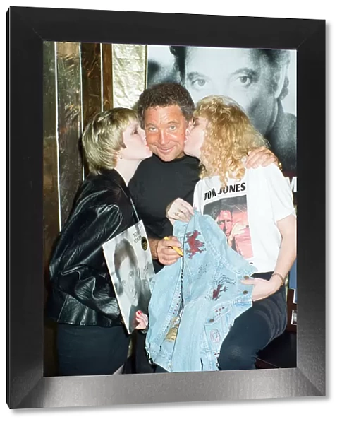 Tom Jones poses with fans Kathy Hall and Rosina Sims at HMV Oxford Street