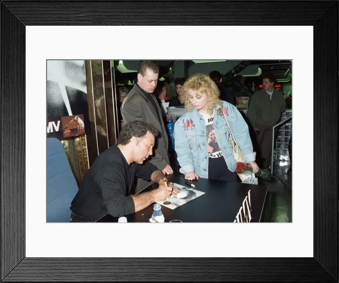 Framed Print : Tom Jones signs the knickers and jacket of his fan Kathy Hall at HMV Oxford Street