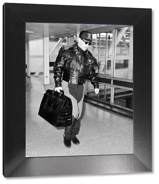 Elton John at Heathrow Airport, London. 25th September 1987