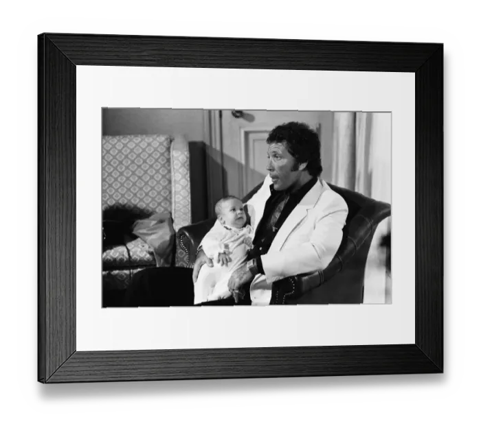 Framed Print : Tom Jones with his grandson Alexander, aged eleven months, in their London hotel Framed Print : Tom Jones with his grandson Alexander, aged eleven months, in their London hotel