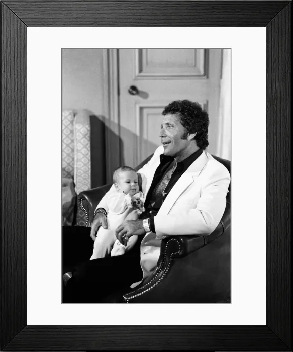 Framed Print : Tom Jones with his grandson Alexander, aged eleven months, in their London hotel Framed Print : Tom Jones with his grandson Alexander, aged eleven months, in their London hotel