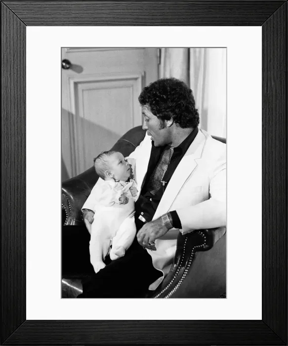Framed Print : Tom Jones with his grandson Alexander, aged eleven months, in their London hotel Framed Print : Tom Jones with his grandson Alexander, aged eleven months, in their London hotel