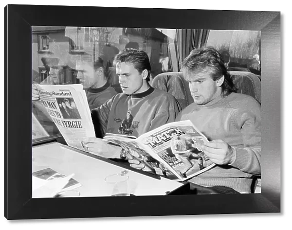 John Scales (left - reading The Evening Standard) travelling on the team coach