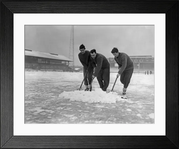 Framed Print : Grounds staff at Bristol Rovers Eastville Stadium struggle to clear snow from the pitch