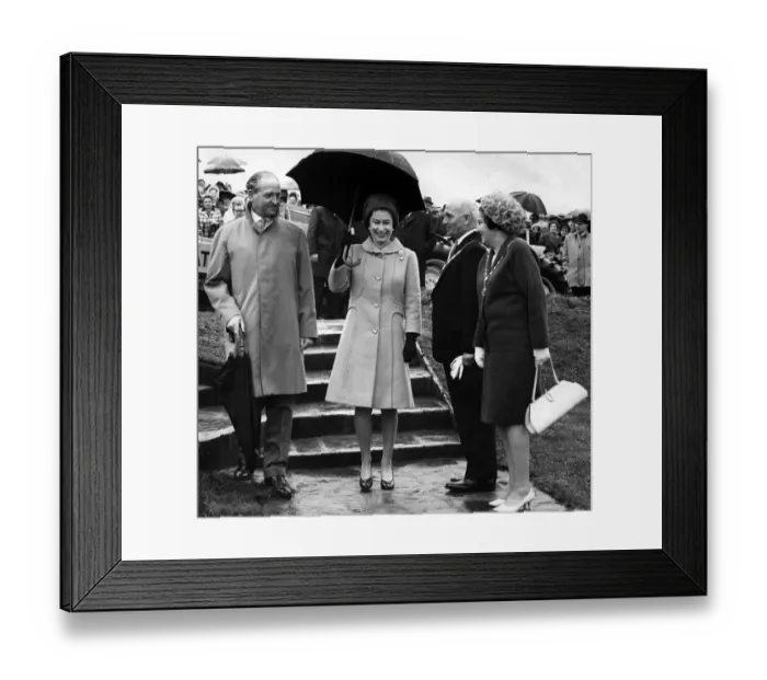 Framed Print : Queen Elizabeth II walks from the tree planting at Werneth Low carrying an umbrella to Framed Print : Queen Elizabeth II walks from the tree planting at Werneth Low carrying an umbrella to