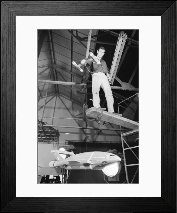 Framed Print : Thunderbird II takes off in Slough film studios during filming of the Thunderbirds series Framed Print : Thunderbird II takes off in Slough film studios during filming of the Thunderbirds series