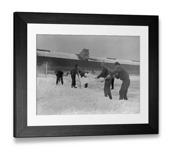Framed Print : Grounds staff at Bristol Rovers Eastville Stadium struggle to clear snow from the pitch