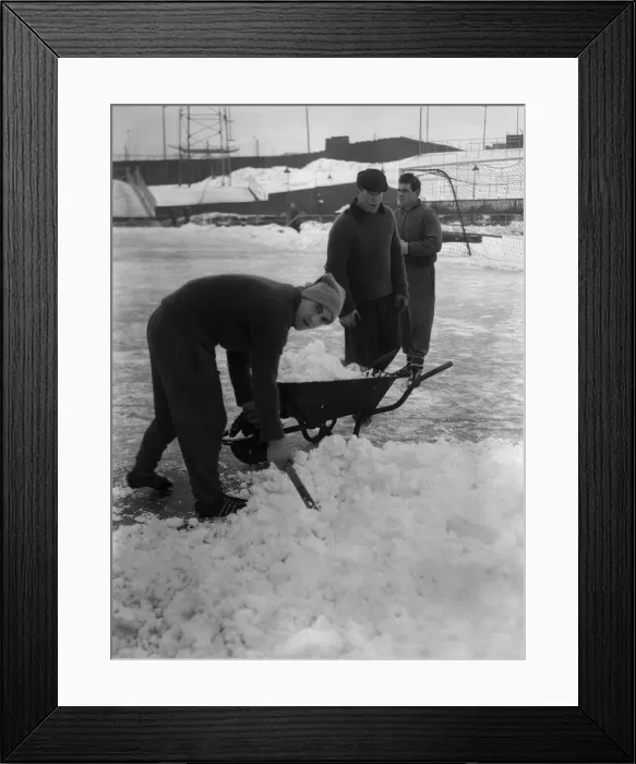 Framed Print : Grounds staff at Bristol Rovers Eastville Stadium struggle to clear snow from the pitch