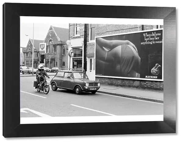Scenes in Quicks Road, South Wimbledon, showing a billboard poster for Ratners