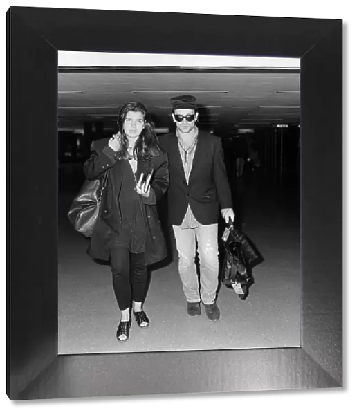 Bono of rock group U2 and his wife Ali pictured at London Airport. 16th July 1987