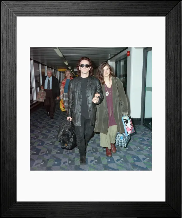 Framed Print : Bono of rock group U2 and his wife Ali pictured at London Airport. 10th October 1991 Framed Print : Bono of rock group U2 and his wife Ali pictured at London Airport. 10th October 1991