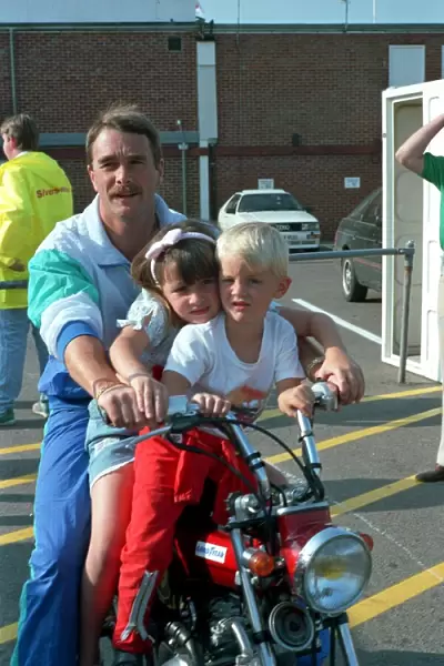 NIGEL MANSELL AND CHILDREN CHLOE MANSELL AND GREG MANSELL ON A BIKE AT THE FORMULA 1