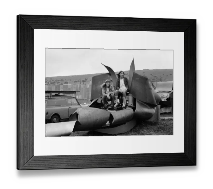 Framed Print : Isle of Wight Festival. Two Swedish hippy types sitting on top of cars that look like