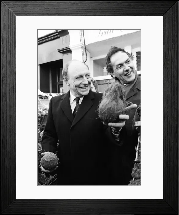 Framed Print : Labour leader Neil Kinnock juggles with produce at a market in Wandsworth, London Framed Print : Labour leader Neil Kinnock juggles with produce at a market in Wandsworth, London