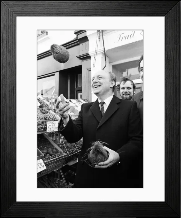 Framed Print : Labour leader Neil Kinnock juggles with produce at a market in Wandsworth, London