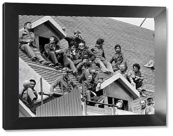 The royal tour of Switzerland. Pictured, locals sitting on a roof hoping to see the royal