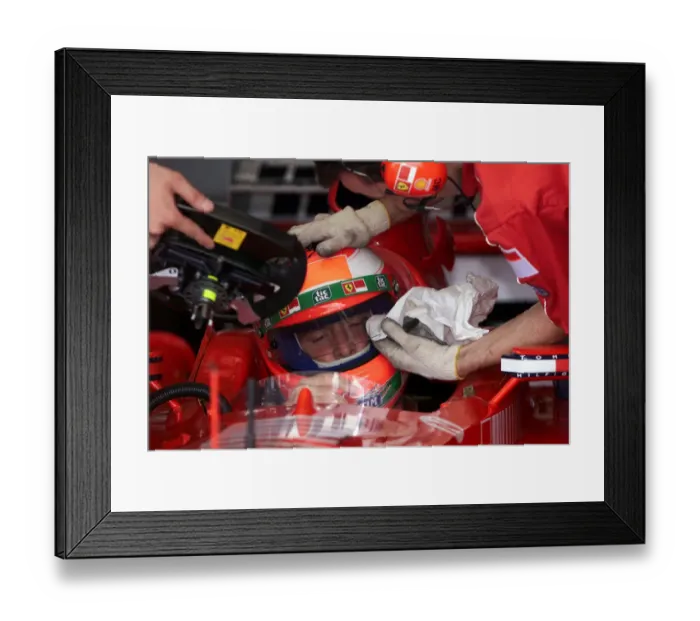 Framed Print : Eddie Irvine gets some personal attention in the pits The 1999 British Grand